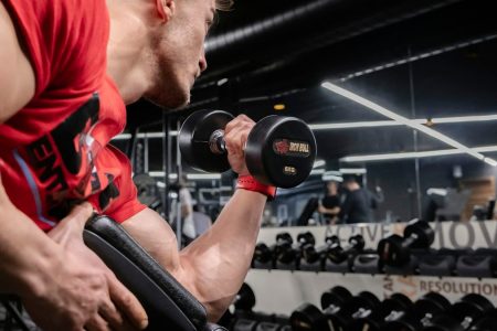 a man lifting a dumbbell in a gym